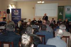 Zdjęcie przedstawia uczestników debaty, jeden z prelegentów omawia temat dotyczący bezpieczeństwa na wsi.